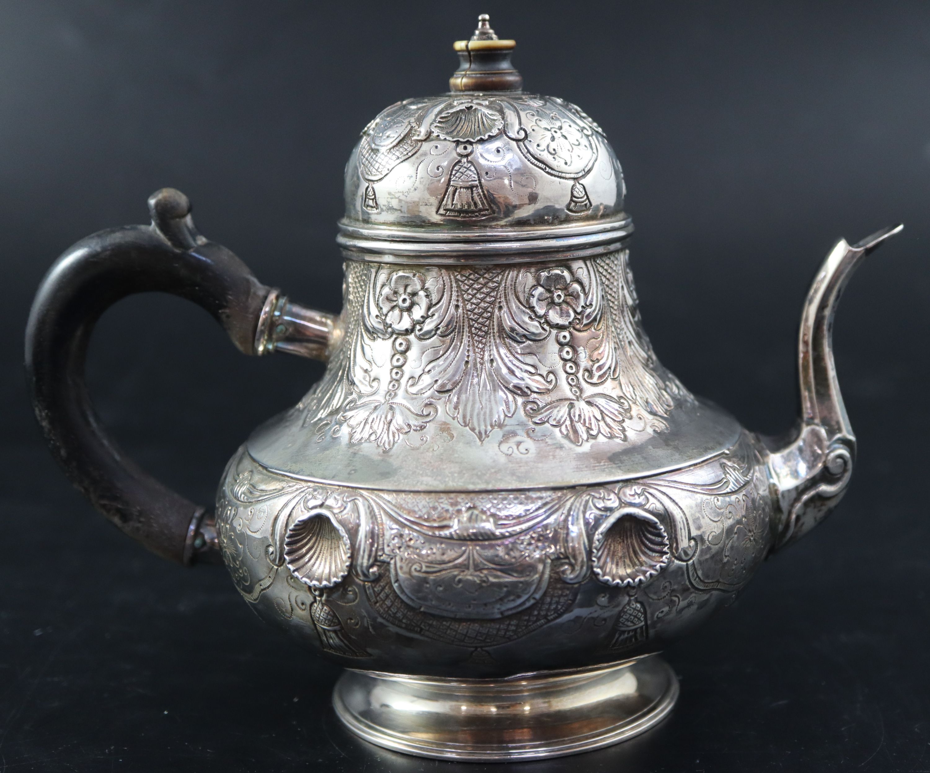A late 18th/early 19th century Dutch embossed white metal pear shaped teapot, height 15.3cm, gross 10oz.